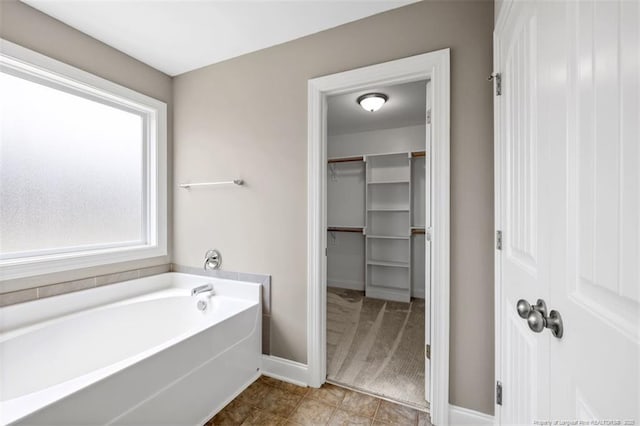 17 Tanawha Ct, Spring Lake, NC 28390 - bathroom with a garden tub and a walk in closet