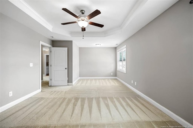 17 Tanawha Ct, Spring Lake, NC 28390 - spare room featuring a raised ceiling, ceiling fan, light carpet, and ornamental molding