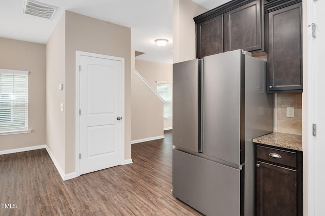 516 Smithridge Way, Fuquay Varina, NC 27526 - kitchen with freestanding refrigerator, wood finished floors, dark brown cabinetry, and tasteful backsplash