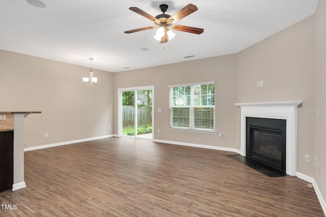516 Smithridge Way, Fuquay Varina, NC 27526 - unfurnished living room featuring dark wood-type flooring, a fireplace with flush hearth, ceiling fan, and a chandelier