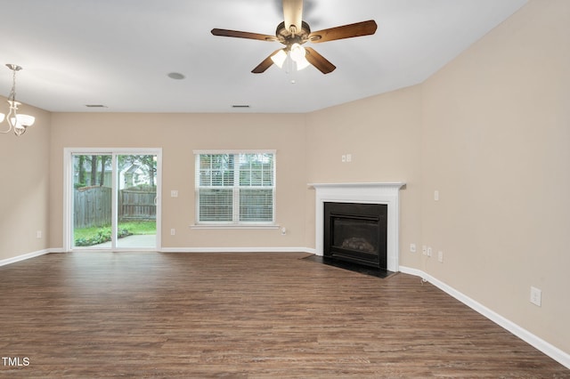 516 Smithridge Way, Fuquay Varina, NC 27526 - unfurnished living room featuring dark wood-style flooring, a ceiling fan, and a fireplace with flush hearth