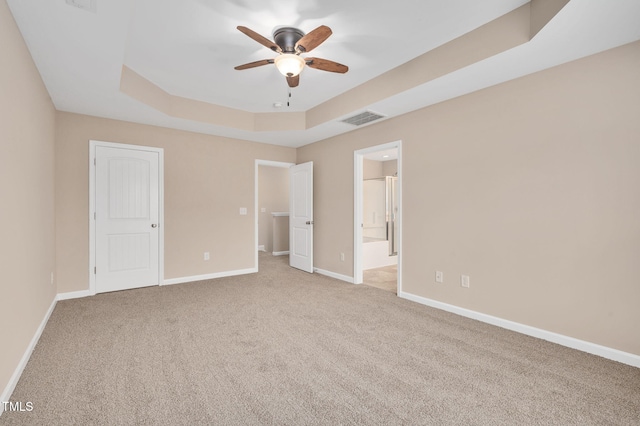 516 Smithridge Way, Fuquay Varina, NC 27526 - unfurnished bedroom with a raised ceiling, carpet floors, and connected bathroom
