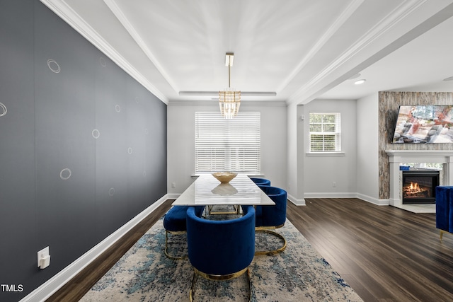 1705 Pointe Xing, Apex, NC 27523 - dining room with a raised ceiling, dark wood-style floors, a fireplace, ornamental molding, and a chandelier