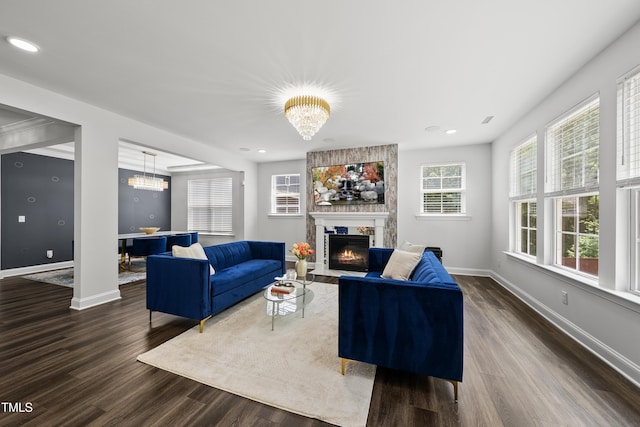 1705 Pointe Xing, Apex, NC 27523 - living room featuring a large fireplace, dark wood-type flooring, recessed lighting, and a chandelier