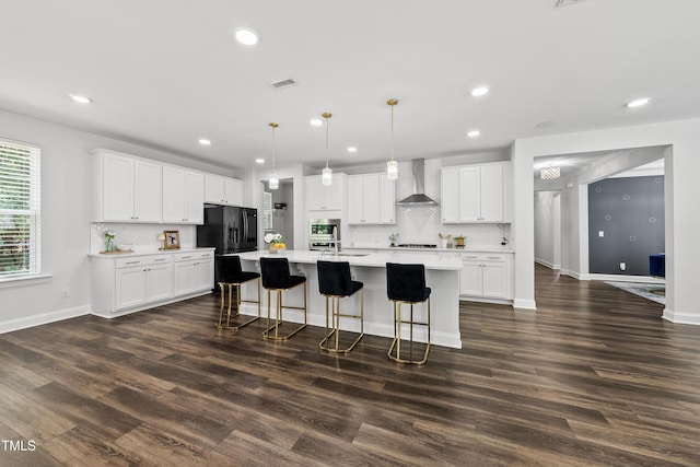 1705 Pointe Xing, Apex, NC 27523 - kitchen with wall chimney range hood, black fridge, tasteful backsplash, dark wood-type flooring, and recessed lighting
