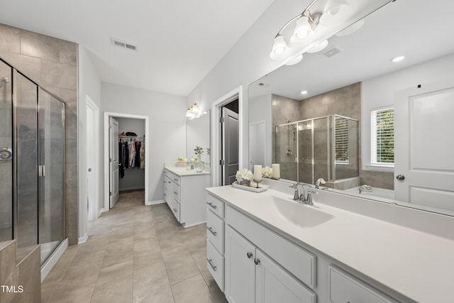 1705 Pointe Xing, Apex, NC 27523 - full bathroom featuring vanity, a stall shower, a walk in closet, and tile patterned floors