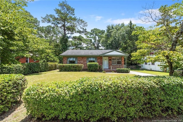 1109 Chesterfield Dr, Fayetteville, NC 28305 - view of front of house with a front yard, brick siding, and a porch