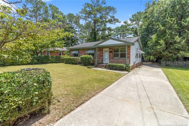 1109 Chesterfield Dr, Fayetteville, NC 28305 - bungalow-style home with driveway, a front lawn, and brick siding