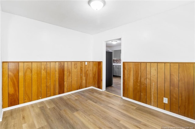 1109 Chesterfield Dr, Fayetteville, NC 28305 - empty room featuring a wainscoted wall, wood finished floors, and wooden walls