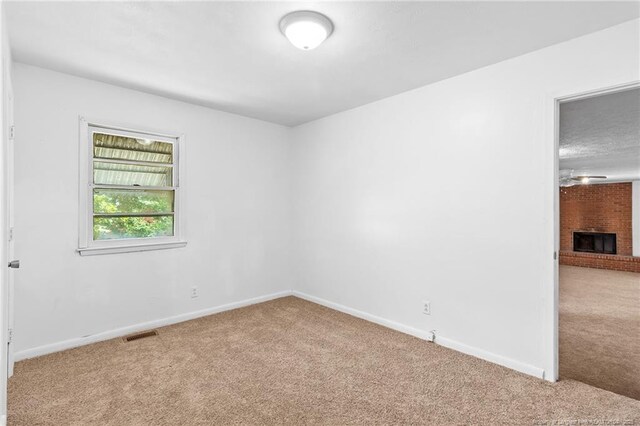 1109 Chesterfield Dr, Fayetteville, NC 28305 - empty room with carpet floors and a fireplace