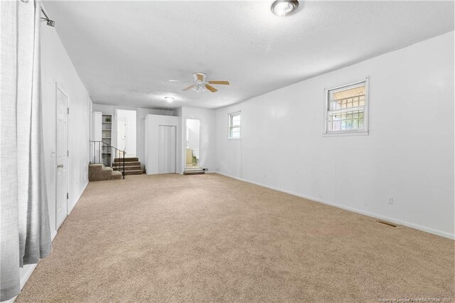 1109 Chesterfield Dr, Fayetteville, NC 28305 - carpeted spare room featuring ceiling fan and stairs