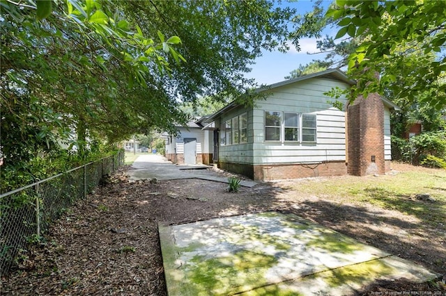 1109 Chesterfield Dr, Fayetteville, NC 28305 - view of home's exterior featuring a patio area and driveway