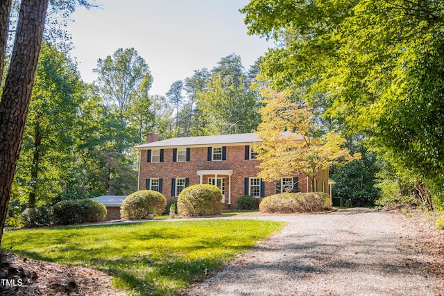 70 Sand Trap Ln, Roxboro, NC 27574 - view of front of property with brick siding, a chimney, and a front yard