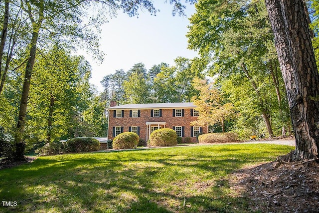 70 Sand Trap Ln, Roxboro, NC 27574 - colonial-style house featuring brick siding, a front yard, and a chimney