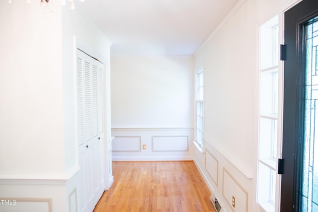 70 Sand Trap Ln, Roxboro, NC 27574 - corridor featuring a decorative wall, light wood-type flooring, wainscoting, and crown molding