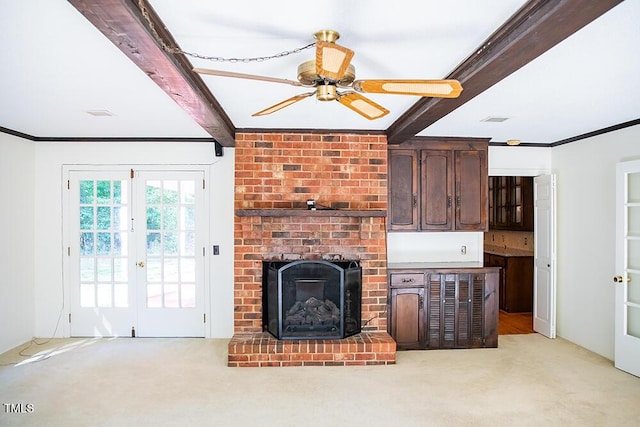 70 Sand Trap Ln, Roxboro, NC 27574 - living room featuring beamed ceiling, light carpet, a ceiling fan, crown molding, and a brick fireplace