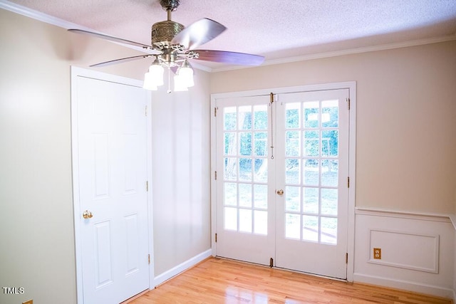 70 Sand Trap Ln, Roxboro, NC 27574 - doorway with french doors, crown molding, light wood finished floors, ceiling fan, and a textured ceiling