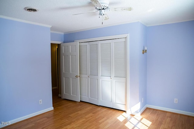 70 Sand Trap Ln, Roxboro, NC 27574 - unfurnished bedroom with wood finished floors, a closet, ornamental molding, a ceiling fan, and a textured ceiling