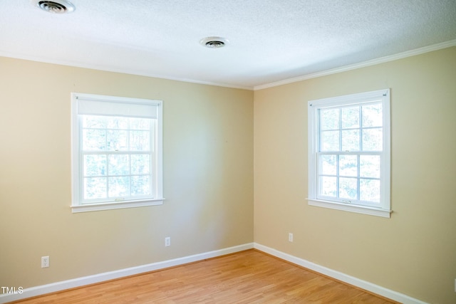 70 Sand Trap Ln, Roxboro, NC 27574 - empty room with light wood-style flooring, ornamental molding, and a textured ceiling