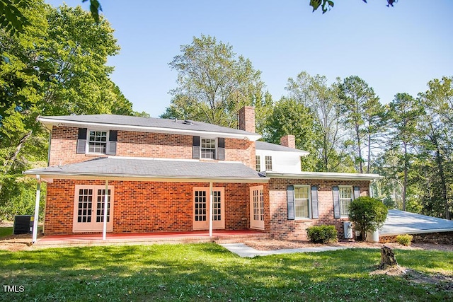 70 Sand Trap Ln, Roxboro, NC 27574 - rear view of property with french doors, a chimney, a lawn, and a patio area