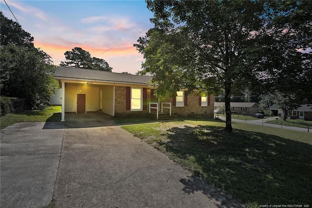 2619 Dumfries Dr, Fayetteville, NC 28306 - ranch-style home with concrete driveway, a front lawn, an attached carport, and brick siding