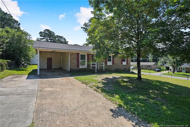 2619 Dumfries Dr, Fayetteville, NC 28306 - single story home with concrete driveway, a front yard, an attached carport, and brick siding
