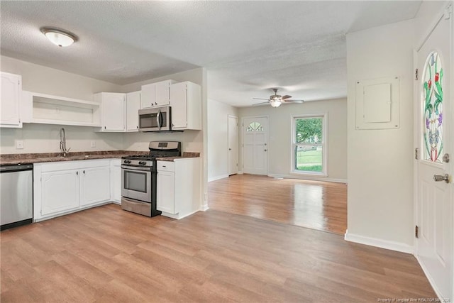 2619 Dumfries Dr, Fayetteville, NC 28306 - kitchen featuring stainless steel appliances, open shelves, ceiling fan, dark countertops, and light wood-style floors