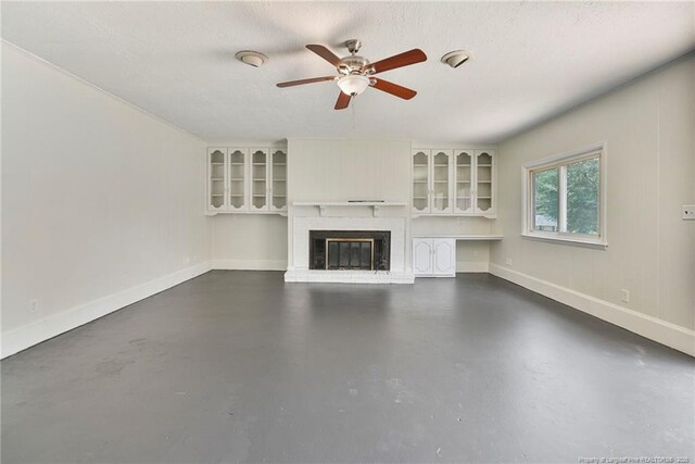 2619 Dumfries Dr, Fayetteville, NC 28306 - unfurnished living room featuring finished concrete floors, ceiling fan, and a fireplace