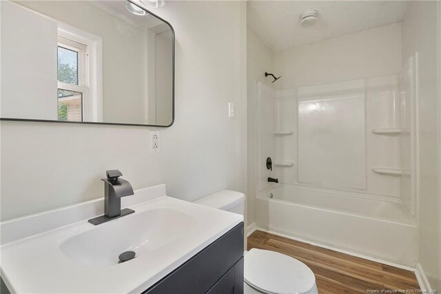 2619 Dumfries Dr, Fayetteville, NC 28306 - bathroom with wood finished floors, vanity, and washtub / shower combination