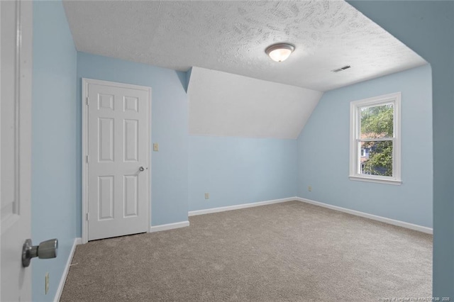 3464 Mcchoen Dr, Fayetteville, NC 28311 - bonus room featuring carpet flooring, a textured ceiling, and vaulted ceiling