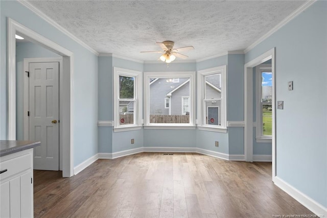 3464 Mcchoen Dr, Fayetteville, NC 28311 - unfurnished dining area with ceiling fan, wood-type flooring, a textured ceiling, and crown molding