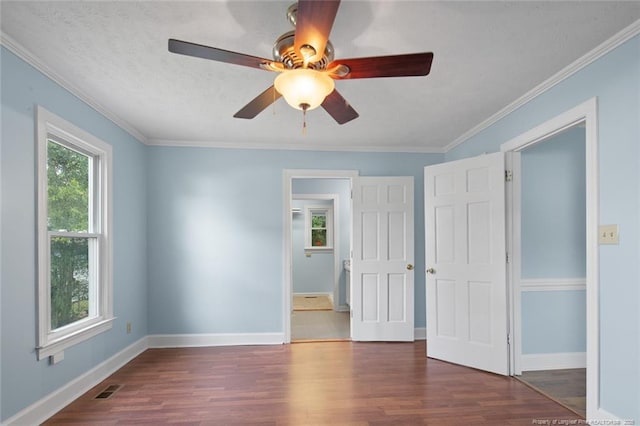 3464 Mcchoen Dr, Fayetteville, NC 28311 - unfurnished bedroom featuring dark wood finished floors, ornamental molding, and a ceiling fan