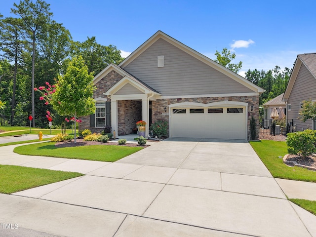 1372 Prevenient Dr, Wake Forest, NC 27587 - craftsman house with driveway, an attached garage, and stone siding