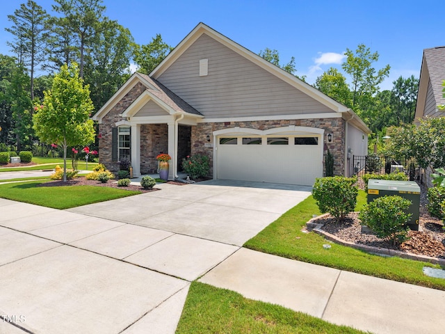 1372 Prevenient Dr, Wake Forest, NC 27587 - view of front of property with stone siding, a garage, and concrete driveway