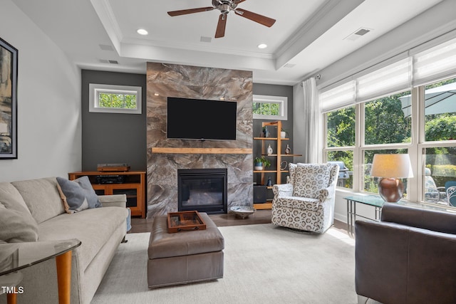 1372 Prevenient Dr, Wake Forest, NC 27587 - living area featuring a raised ceiling, ceiling fan, crown molding, a high end fireplace, and wood finished floors