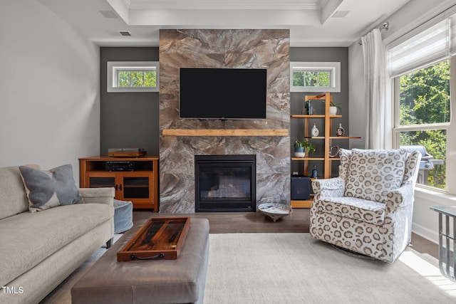 1372 Prevenient Dr, Wake Forest, NC 27587 - living area featuring wood finished floors, a premium fireplace, healthy amount of natural light, crown molding, and a tray ceiling