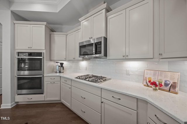 1372 Prevenient Dr, Wake Forest, NC 27587 - kitchen with stainless steel appliances, crown molding, light stone countertops, decorative backsplash, and dark wood-style floors