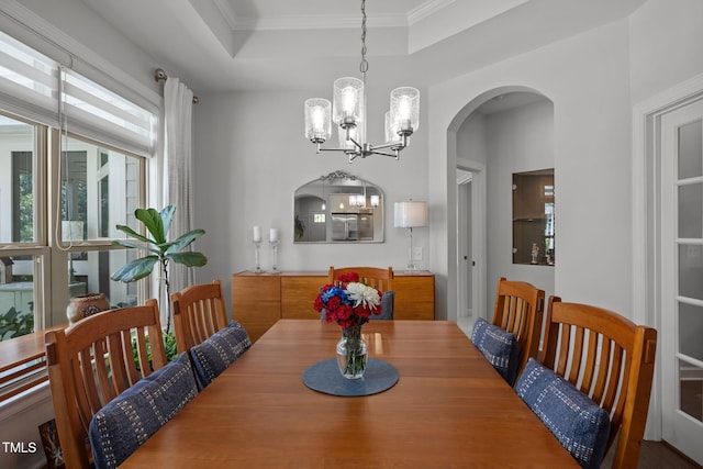1372 Prevenient Dr, Wake Forest, NC 27587 - dining room featuring a chandelier, a raised ceiling, arched walkways, and ornamental molding
