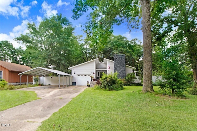 308 Spring Creek Rd, Goldsboro, NC 27534 - mid-century home featuring a detached carport, a front lawn, a chimney, and driveway
