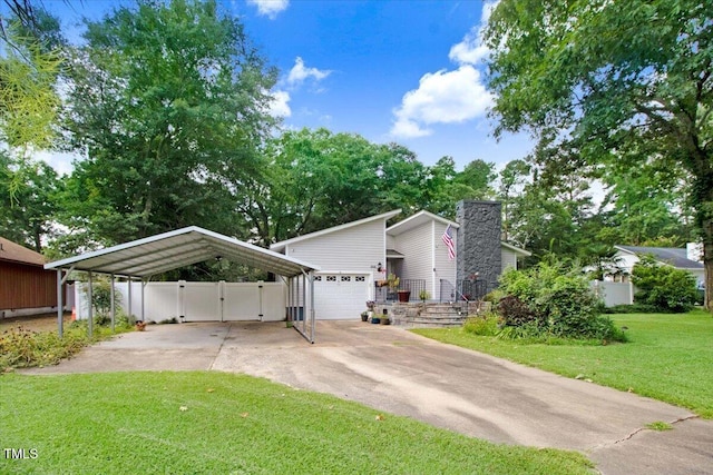 308 Spring Creek Rd, Goldsboro, NC 27534 - mid-century modern home featuring driveway, a gate, a carport, a chimney, and an attached garage