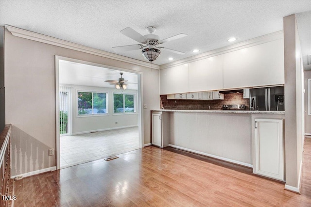 308 Spring Creek Rd, Goldsboro, NC 27534 - kitchen featuring ceiling fan, ornamental molding, black fridge, decorative backsplash, and a textured ceiling