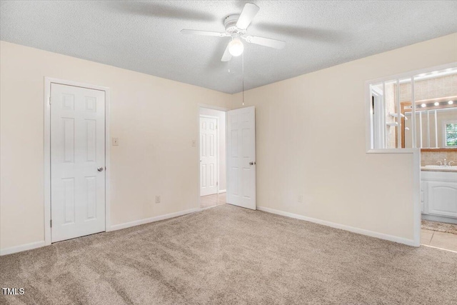 308 Spring Creek Rd, Goldsboro, NC 27534 - unfurnished bedroom featuring carpet flooring, connected bathroom, a textured ceiling, and a ceiling fan