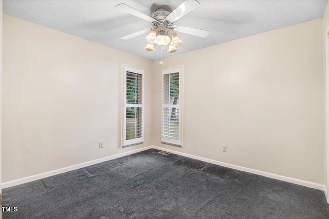 308 Spring Creek Rd, Goldsboro, NC 27534 - spare room featuring dark colored carpet and a ceiling fan