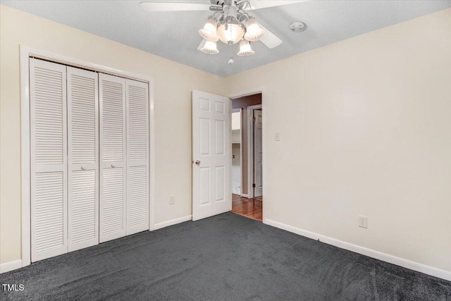 308 Spring Creek Rd, Goldsboro, NC 27534 - unfurnished bedroom featuring dark colored carpet, a closet, and a ceiling fan