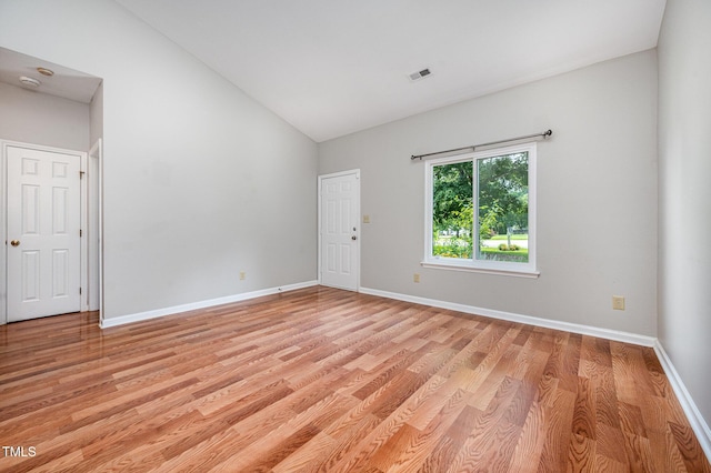 6 Blake Ct, Durham, NC 27712 - unfurnished room featuring vaulted ceiling, light wood finished floors, and a smoke detector