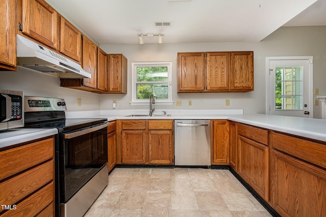 6 Blake Ct, Durham, NC 27712 - kitchen featuring stainless steel appliances, under cabinet range hood, and brown cabinets