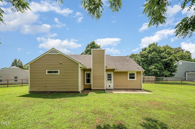 6 Blake Ct, Durham, NC 27712 - back of property with a patio area, a fenced backyard, and a chimney