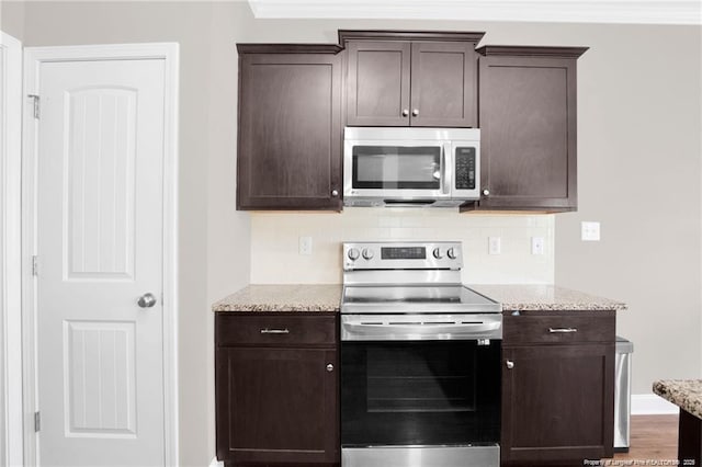 341 Woodington Rd, Hope Mills, NC 28348 - kitchen with stainless steel appliances, dark brown cabinets, tasteful backsplash, and light stone countertops