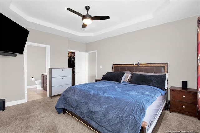 341 Woodington Rd, Hope Mills, NC 28348 - bedroom with a raised ceiling, light colored carpet, ensuite bath, ceiling fan, and a spacious closet
