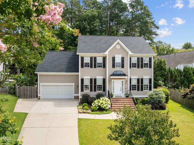1802 Abby Knoll Dr, Apex, NC 27502 - colonial house featuring concrete driveway, an attached garage, and a shingled roof